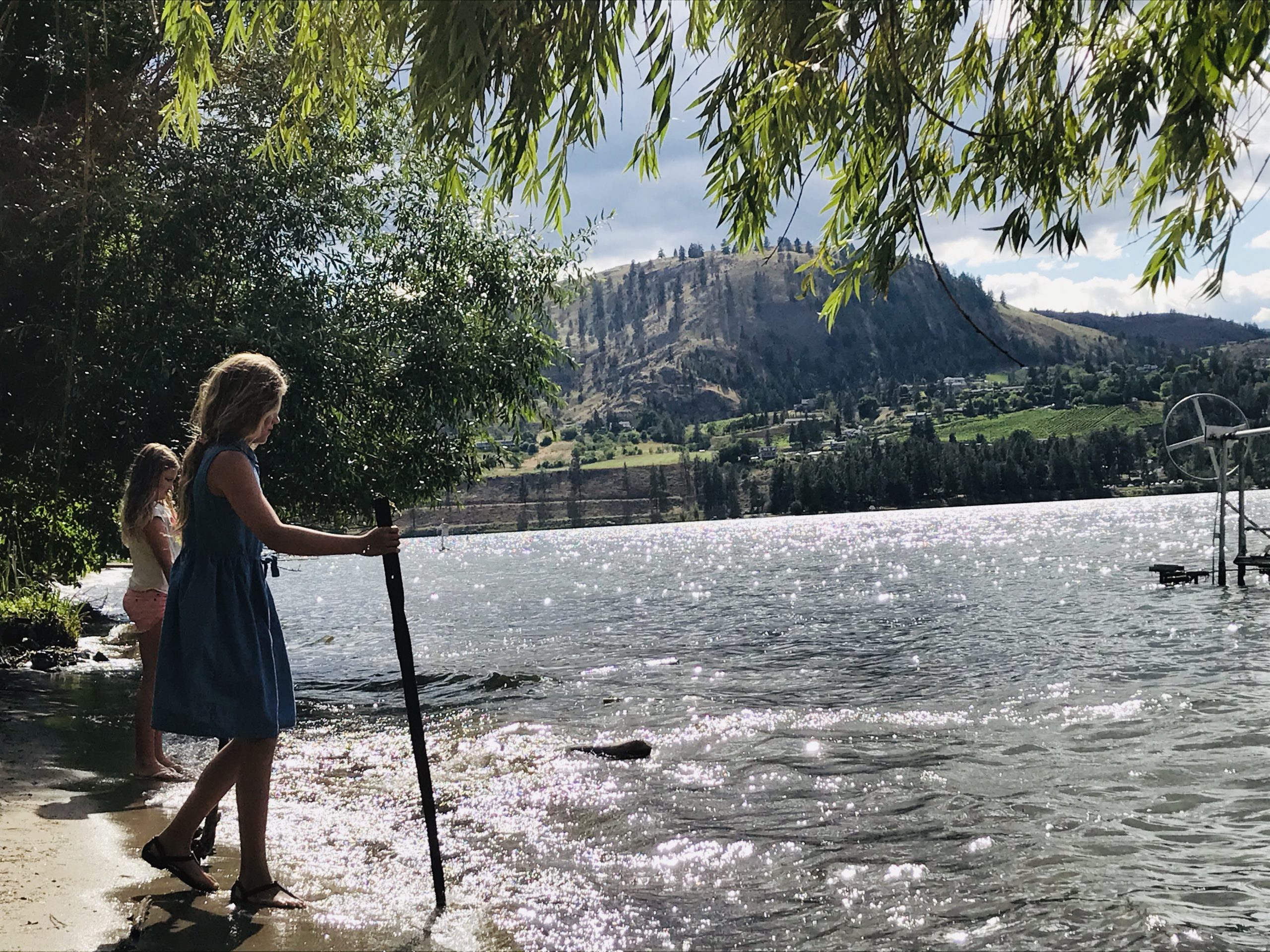 Grandmother and grand daughter next to lake
