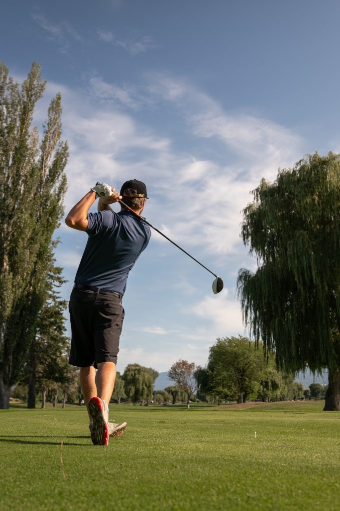 Golfer follow thru after tee shot